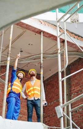 Builders discussing roof renovation