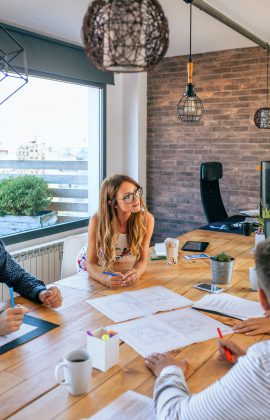 Businesswoman in a work meeting looking at construction drawings